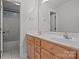Bright bathroom with a double sink vanity, a large mirror, and a walk-in shower offering convenience and comfort at 214 Harbor Landing Dr, Mooresville, NC 28117