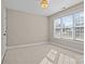 Bright bedroom with neutral carpet, a window with blinds, and minimal decor creating a calm and inviting space at 214 Harbor Landing Dr, Mooresville, NC 28117