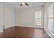 This cozy bedroom with a large window features a hardwood floor and neutral-colored walls at 214 Harbor Landing Dr, Mooresville, NC 28117