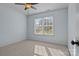 Light-filled bedroom with neutral walls and carpet, featuring a window with blinds and a simple, clean aesthetic at 214 Harbor Landing Dr, Mooresville, NC 28117