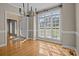 Bright dining room with hardwood floors and a large window offering a view of the outdoors at 214 Harbor Landing Dr, Mooresville, NC 28117