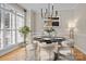 Cozy dining room featuring a modern chandelier, stylish chairs, and elegant marble table at 214 Harbor Landing Dr, Mooresville, NC 28117