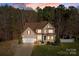 Charming two-story home features a manicured front lawn, attached garage, and classic architectural details at 214 Harbor Landing Dr, Mooresville, NC 28117