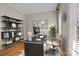 Bright home office featuring modern black desk, world map art, and ample natural light from the window at 214 Harbor Landing Dr, Mooresville, NC 28117