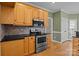 Well-equipped kitchen features stainless steel appliances, light wood cabinets, and elegant black countertops at 214 Harbor Landing Dr, Mooresville, NC 28117