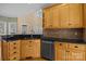 Cozy kitchen featuring wooden cabinets, granite countertops, and stainless steel dishwasher at 214 Harbor Landing Dr, Mooresville, NC 28117