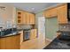 Charming kitchen featuring wooden cabinets, granite countertops, and stainless steel appliances at 214 Harbor Landing Dr, Mooresville, NC 28117