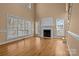 Bright and airy living room featuring a fireplace, large windows, and hardwood floors at 214 Harbor Landing Dr, Mooresville, NC 28117