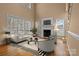 Spacious living room with a fireplace, multiple windows, and neutral-toned furniture at 214 Harbor Landing Dr, Mooresville, NC 28117