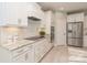 Well-equipped kitchen with granite countertops, tile backsplash, and stainless steel refrigerator at 2150 Millennium Dr # 094, Lancaster, SC 29720