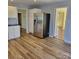 Modern kitchen featuring stainless steel refrigerator, wood-look flooring, and access to other rooms at 2848 Briar Ridge Dr, Charlotte, NC 28270