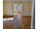 Open living room with hardwood floors leading to dining area with natural light at 2848 Briar Ridge Dr, Charlotte, NC 28270