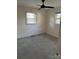 Simple bedroom with grey carpeting, neutral walls, and natural light at 303 S Eastway Dr, Troutman, NC 28166