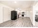 Well-lit kitchen featuring white cabinetry and modern appliances at 303 S Eastway Dr, Troutman, NC 28166