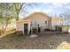 Back exterior of home featuring rear entrance, small porch, and fenced yard at 308 W Charlotte Ave, Mount Holly, NC 28120