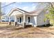 Charming home featuring a welcoming front porch with rocking chairs at 308 W Charlotte Ave, Mount Holly, NC 28120