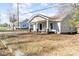 Adorable home displaying a charming front porch with comfortable seating at 308 W Charlotte Ave, Mount Holly, NC 28120