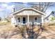 Inviting home showcasing a classic porch with seating and curb appeal at 308 W Charlotte Ave, Mount Holly, NC 28120