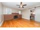 Spacious room with refinished hardwood floors and fireplace feature at 308 W Charlotte Ave, Mount Holly, NC 28120