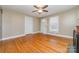 Bright room features hardwood floors and ceiling fan at 308 W Charlotte Ave, Mount Holly, NC 28120