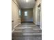 Hallway with gray wood-look vinyl flooring and neutral walls with two windows at 345 Mountain View St, Gastonia, NC 28052