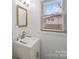 Clean bathroom with a white vanity, modern sink, and bright natural light at 3501 Winterfield Pl, Charlotte, NC 28205