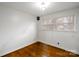 Bright bedroom with hardwood floors, light walls, and natural light from the window at 3501 Winterfield Pl, Charlotte, NC 28205