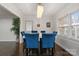 Bright dining area with a modern chandelier, large windows, and stylish blue chairs at 3501 Winterfield Pl, Charlotte, NC 28205