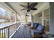 Inviting front porch with comfortable seating, ceiling fans, and a view of the neighborhood street at 3501 Winterfield Pl, Charlotte, NC 28205