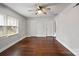 Bright room with hardwood floors, multiple doors, and a ceiling fan for added comfort at 3501 Winterfield Pl, Charlotte, NC 28205