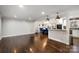 Spacious living room with hardwood floors, white walls, and an open floor plan at 3501 Winterfield Pl, Charlotte, NC 28205