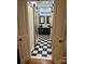 Stylish bathroom featuring double vessel sinks, wood accent wall, and black-and-white checkered flooring at 400 Martin Luther King Jr Ave, Kannapolis, NC 28083