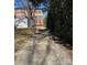 Overgrown gravel driveway lined with greenery and trees at 400 Martin Luther King Jr Ave, Kannapolis, NC 28083
