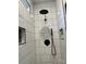 Modern walk-in shower featuring large white tiles, matte black fixtures, and recessed shelving at 400 Martin Luther King Jr Ave, Kannapolis, NC 28083