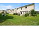 Well-maintained backyard featuring a lush lawn, patio, arbor swing and manicured landscaping at 5006 Sand Trap Ct # 142, Monroe, NC 28112