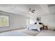 Spacious bedroom featuring tray ceilings, a ceiling fan, and a large window at 5006 Sand Trap Ct # 142, Monroe, NC 28112