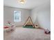 Bright bedroom with a play tent, abacus, and carpeted floor at 5006 Sand Trap Ct # 142, Monroe, NC 28112