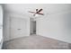 Bright bedroom with a ceiling fan, carpet flooring, and closet with double doors at 5006 Sand Trap Ct # 142, Monroe, NC 28112