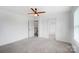 Spacious bedroom features carpet, a ceiling fan, natural light and access to a hallway at 5006 Sand Trap Ct # 142, Monroe, NC 28112