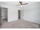 Spacious bedroom features neutral carpet, a ceiling fan, ample natural light, and an open closet at 5006 Sand Trap Ct # 142, Monroe, NC 28112