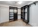 Spacious walk-in closet with dark shelving, offering plenty of storage space at 5006 Sand Trap Ct # 142, Monroe, NC 28112