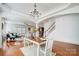 Open-concept dining room with a view into the living room and access to the staircase at 5006 Sand Trap Ct # 142, Monroe, NC 28112