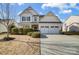 Charming two-story home with a two-car garage, landscaped yard, and inviting front porch at 5006 Sand Trap Ct # 142, Monroe, NC 28112