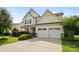 Inviting two-story home with a well-maintained lawn and a two-car garage at 5006 Sand Trap Ct # 142, Monroe, NC 28112