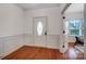 Bright foyer with hardwood floors, paneled walls, and a front door with decorative glass at 5006 Sand Trap Ct # 142, Monroe, NC 28112
