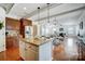 Open kitchen boasts an island, granite counters, stainless steel appliances, and hardwood floors at 5006 Sand Trap Ct # 142, Monroe, NC 28112