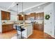 Modern kitchen featuring wood cabinets, granite counters, and a center island with bar seating at 5006 Sand Trap Ct # 142, Monroe, NC 28112