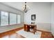 Well-lit office space with natural light, hardwood floors, and an elegant chandelier at 5006 Sand Trap Ct # 142, Monroe, NC 28112