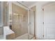 Bright shower featuring glass doors, tile surround, and a built-in shower caddy at 5006 Sand Trap Ct # 142, Monroe, NC 28112