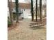 Cozy backyard with a picnic table and a house featuring a deck overlooking the peaceful outdoor space at 5012 Forest Mountain Ct, Charlotte, NC 28227